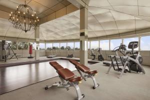 a gym with several exercise bikes and a chandelier at Ramada Plaza By Wyndham, Chandigarh Zirakpur in Chandīgarh