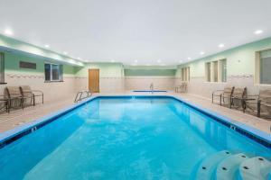 a large swimming pool with chairs and tables at Ramada by Wyndham Coeur d'Alene in Coeur d'Alene