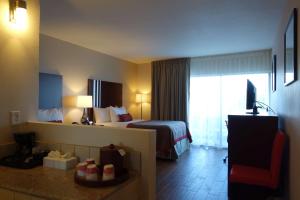 a hotel room with a bed and a window at Ramada by Wyndham Sacramento in Sacramento