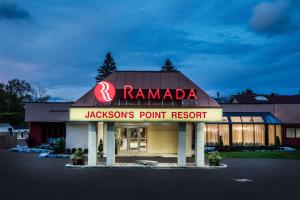 a restaurant with a sign on the front of it at Ramada by Wyndham Jacksons Point in Georgina