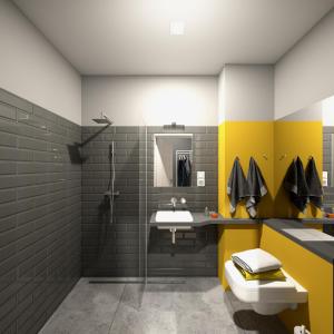 uma casa de banho com paredes amarelas e cinzentas e um lavatório. em La Guitarra Hostel Poznań em Poznań