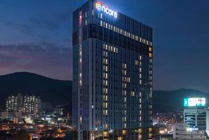 a lit up building with a samsung sign on it at Ramada Encore by Wyndham Busan Haeundae in Busan