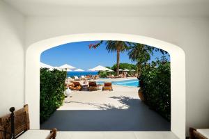 an archway leading to a pool at a resort at Le Calette Bay in Cefalù