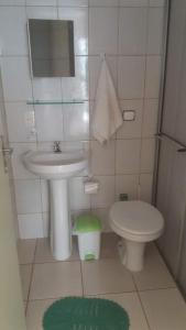 a small bathroom with a sink and a toilet at Pousada Encanto Das Aguas in Lindóia