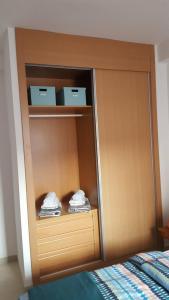 a wooden cabinet with folded towels in a bedroom at Vera Playa Laguna Beach Resort in Vera