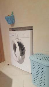 a washing machine in a room with a blue trash can at Vera Playa Laguna Beach Resort in Vera