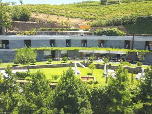 an external view of a building with a garden at Quinta do Vallado - Douro Wine Hotel in Peso da Régua