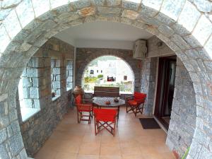 an archway in a stone building with chairs and a table at Mezapos Villa Katerina in Mézapos