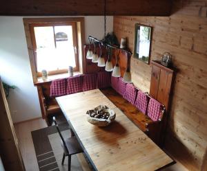 a dining room with a wooden table and a window at Chalet Styria in Donnersbachwald