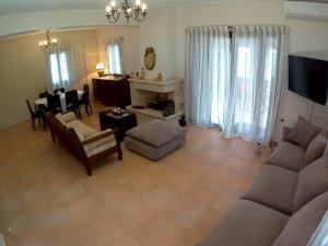 a living room with a couch and a dining room at Mezapos Villa Katerina in Mézapos