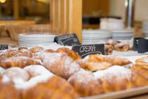 a bunch of donuts on display in a bakery at Sport Hotel Vittoria in Passo del Tonale