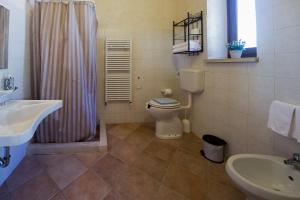 a bathroom with a toilet and a sink and a shower at Valle dell'Acanto in Modica