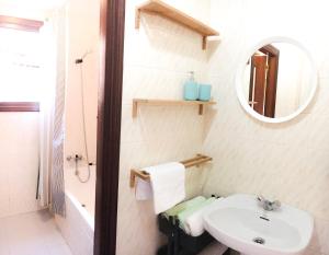a white bathroom with a sink and a mirror at Centrico Y Acogedor in Comillas +13 photos