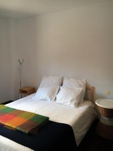 a bed with a colorful blanket on top of it at Centrico Y Acogedor in Comillas