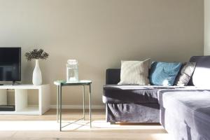 a living room with a couch and a table at KUKU Urban & Family Appartement in Dresden