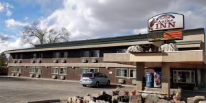 a building with a car parked in front of it at Buffalo Bill's Antlers Inn in Cody