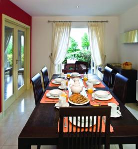 a dining room table with food on it at Ring of Kerry Holiday Cottages No 22 by Trident Holiday Homes in Kenmare +9 photos