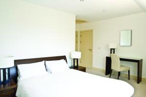 a bedroom with a bed and a desk and a chair at Ring of Kerry Holiday Cottages No 22 by Trident Holiday Homes in Kenmare