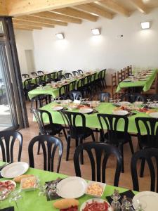 una habitación con mesas verdes y sillas con comida. en Habitacions Casa Roberto en Ontinyent
