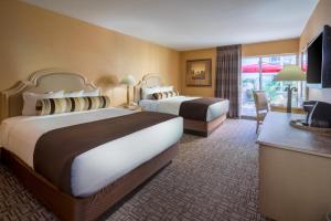 a hotel room with two beds and a television at Golden Nugget Laughlin in Laughlin