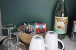 a bottle of wine and two glasses and a bottle of milk at Waitapu Springs B&B in Takaka +28 photos
