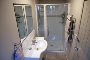 a bathroom with a sink and a shower at For Puffed Pedallers in Mapua +8 photos