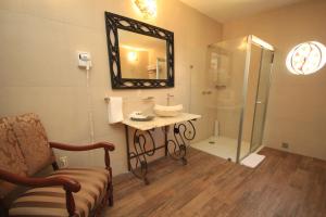 a bathroom with a sink and a shower with a mirror at Hotel Boutique Ponciano in Guanajuato +54 photos