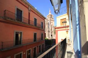a view from a window of an alley with buildings at Hotel Boutique Ponciano in Guanajuato