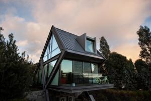 a house with glass windows and a roof at MONA Pavilions in Hobart