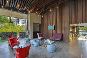 a lobby with red and purple chairs and tables at The Serenity Hua Hin in Hua Hin