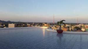a view of a rooftop of a building with a palm tree at River Hotel in Hà Tiên