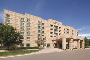 a large white building on a street at Hyatt Place Denver Tech Center in Centennial