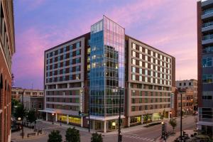 a tall glass building in a city at Hyatt Place Champaign/Urbana in Champaign