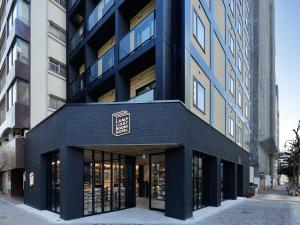 a black building with a black facade at LAMP LIGHT BOOKS HOTEL nagoya in Nagoya