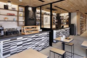 a fast food restaurant with a counter and tables at LAMP LIGHT BOOKS HOTEL nagoya in Nagoya