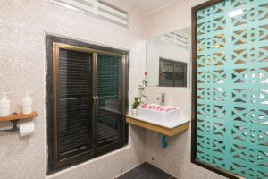 a bathroom with a sink and a mirror at Summer Bliss Boutique in Siem Reap