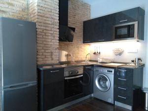 a kitchen with a washing machine and a washer at Valencia-Ruzafa Studio in Valencia