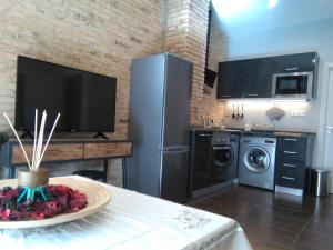 a kitchen with a refrigerator and a washing machine at Valencia-Ruzafa Studio in Valencia