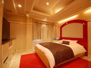 En eller flere senge i et værelse på Hotel Rose (Adult Only)