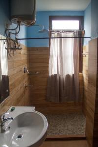 a bathroom with a toilet and a sink and a window at The Barfung Retreat in Gangtok