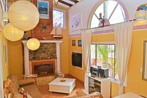 a living room with yellow walls and a fireplace at Amazingly Romantic Vacation for Your Honeymoon in Tijuana
