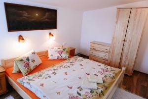 a small bedroom with a bed and a dresser at Penzión Hubert in Zuberec