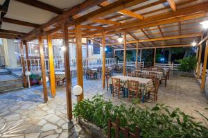 a patio with tables and chairs in a building at Evgatis Hotel in Kondiás