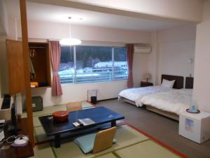 Postel nebo postele na pokoji v ubytování Hotel Yunojin