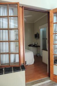 a door leading to a bedroom with a bed at Brackens Guest House in Hillcrest