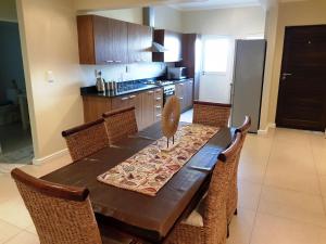 a kitchen with a wooden table with chairs around it at Break-A-Way in Langebaanweg