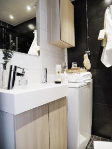 a bathroom with a sink and a washing machine at Roost Kristian in Helsinki