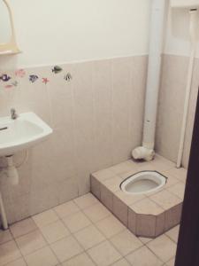 a bathroom with a toilet and a sink at Idaman Sinar Homestay in Nibung Tebal