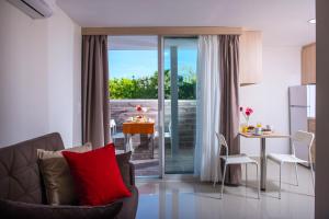 a living room with a couch and a table at Dorian Boutique Hotel-Apartments in Hersonissos