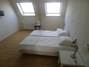 Een bed of bedden in een kamer bij De Gouden Karper